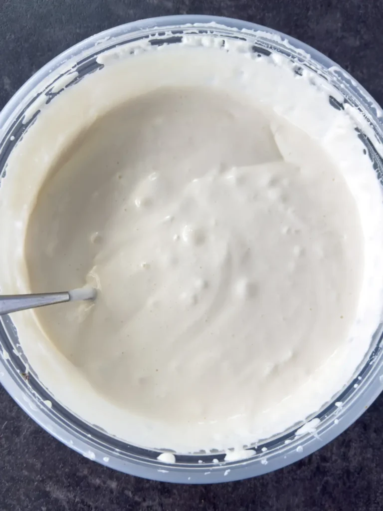 The s'mores dip base in a mixing bowl after beating with a hand mixer.