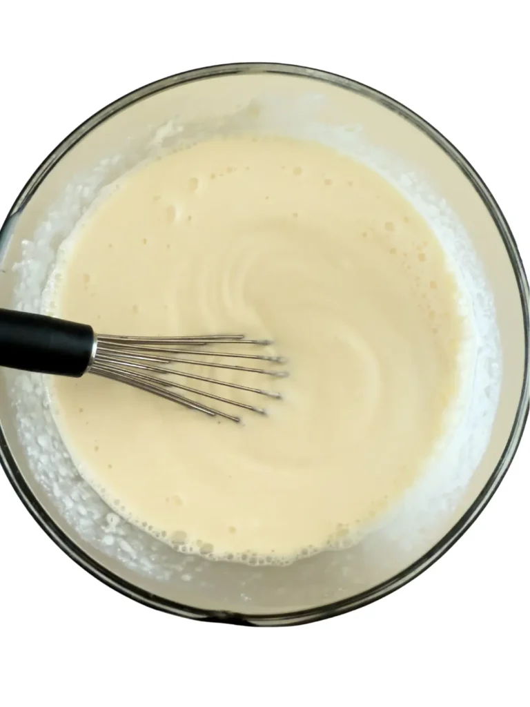 The Greek yogurt pudding in a bowl, whisked until smooth and well-combined.