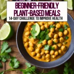 A large bowl of creamy chickpea curry on a table garnished with lime wedges and cilantro.