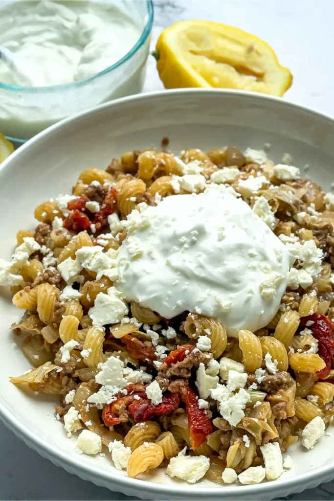 A big bowl of Turkish inspired pasta with garlic yogurt on top.