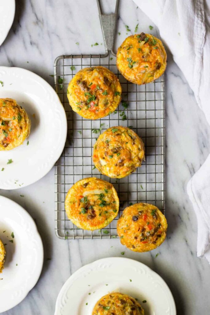 A birds-eye view of mini egg muffins on a cooling rack.