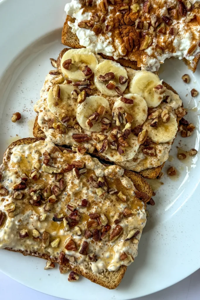 A birds-eye view of three pieces of cottage cheese and pumpkin toast on a white plate.