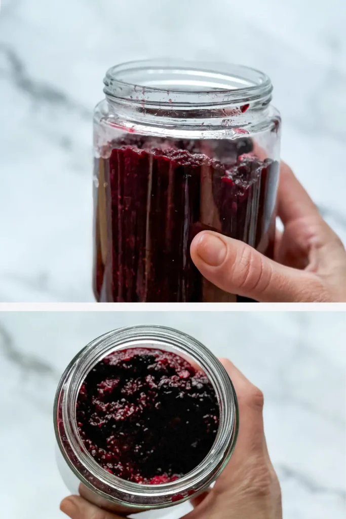 Chia seed jam in a glass jar in someone's hand.