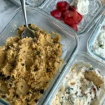 A counter full of snack prepped items like chickpea cookie dough, cottage cheese dips and chia pudding.
