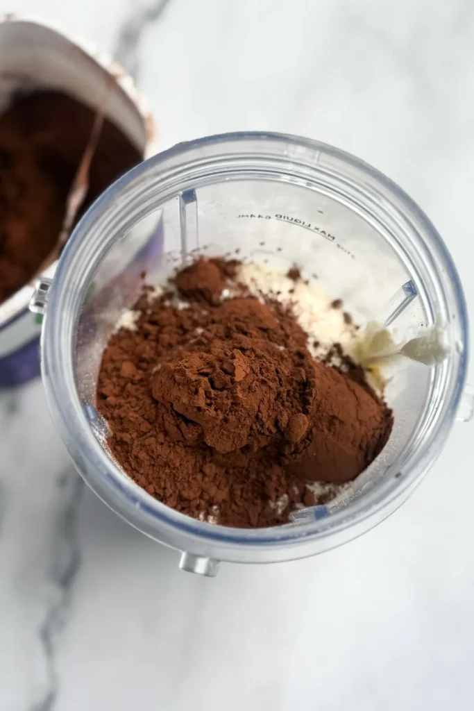 All the ingredients for the chia pudding added to a blender cup.