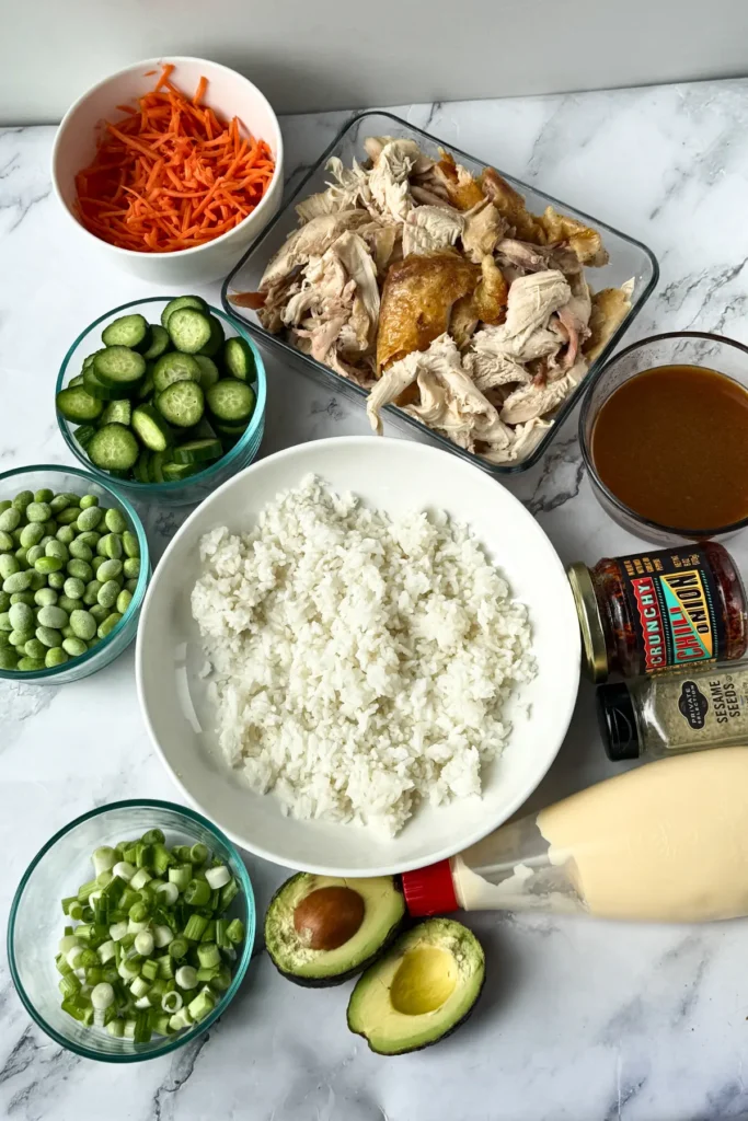 The ingredients for the Asian-inspired chicken and rice bowl portioned out on a counter. 