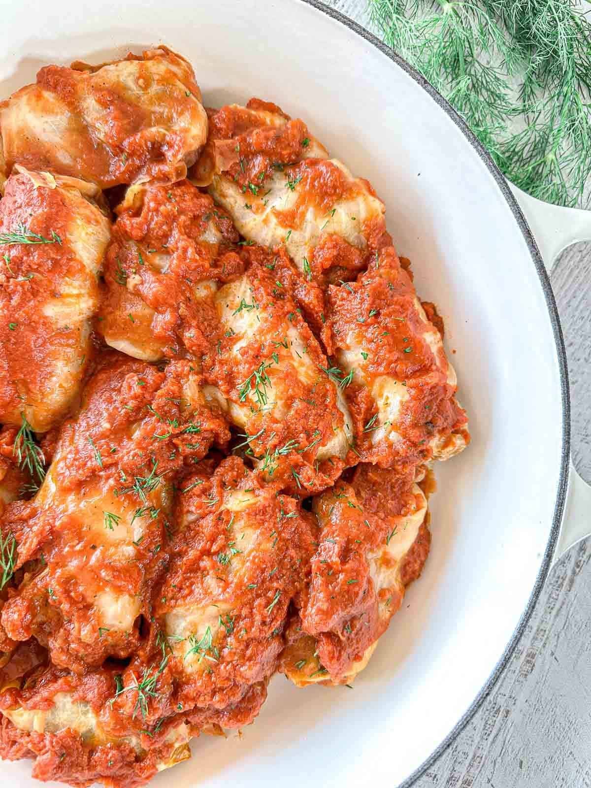 A large dutch oven with stuffed cabbage rolls in it after cooking. 