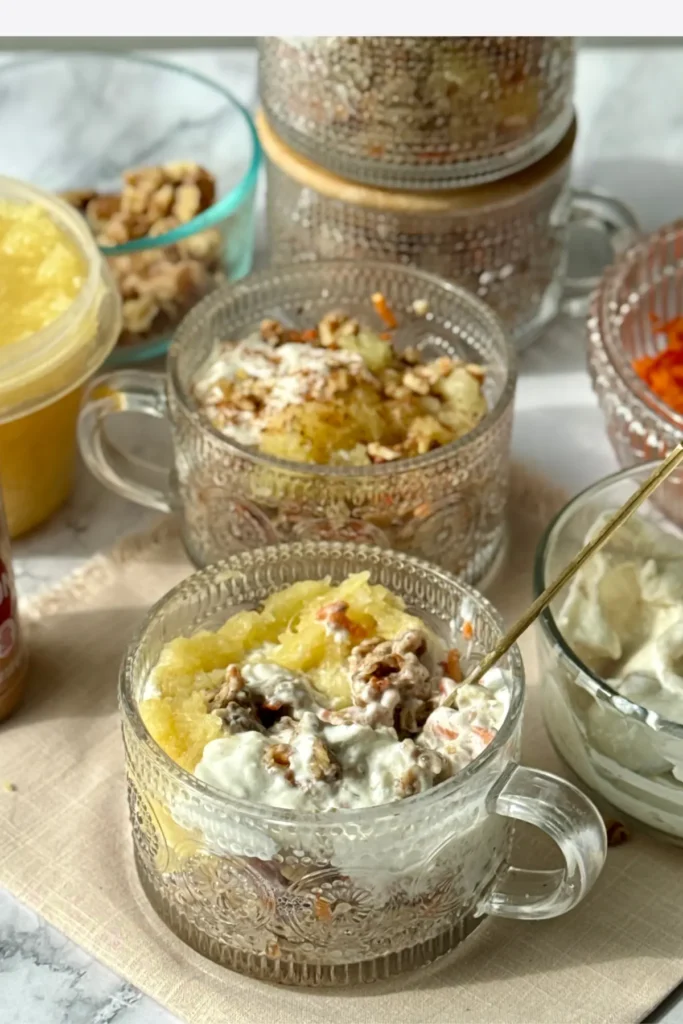 A counter with loaded oatmeal bowls, two of which have the lids on for meal prep, surrounded by toppings for assembly. 