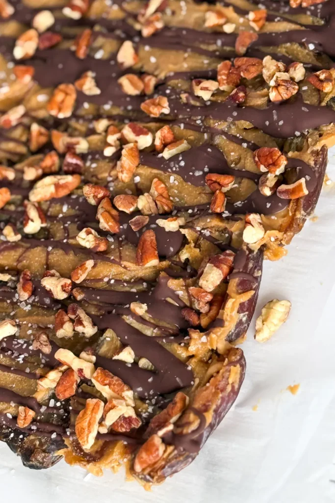 Maple pecan date bark before slicing into pieces right out of the freezer on parchment paper. 