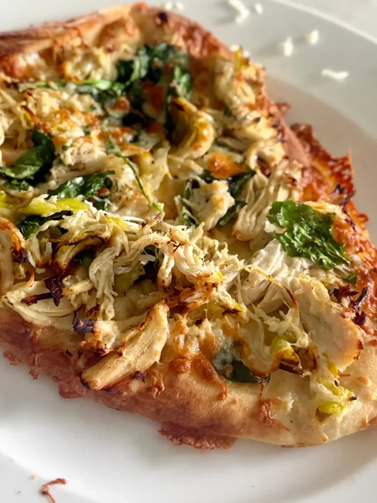 A pepperoncini chicken flatbread on a white plate.