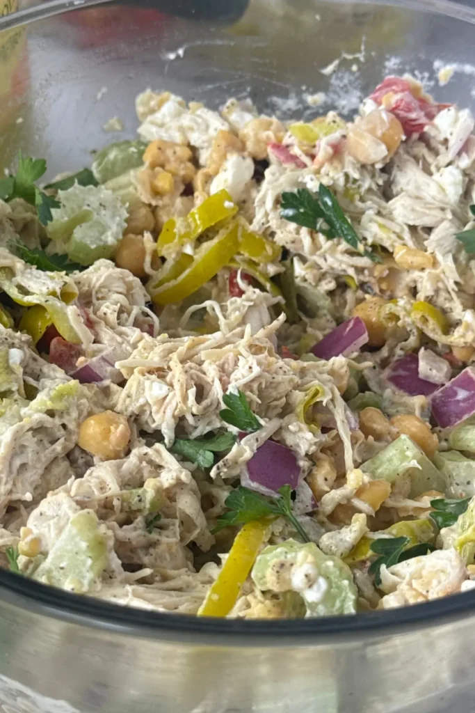 A close-up of the peperoncini chicken salad in a large glass bowl.