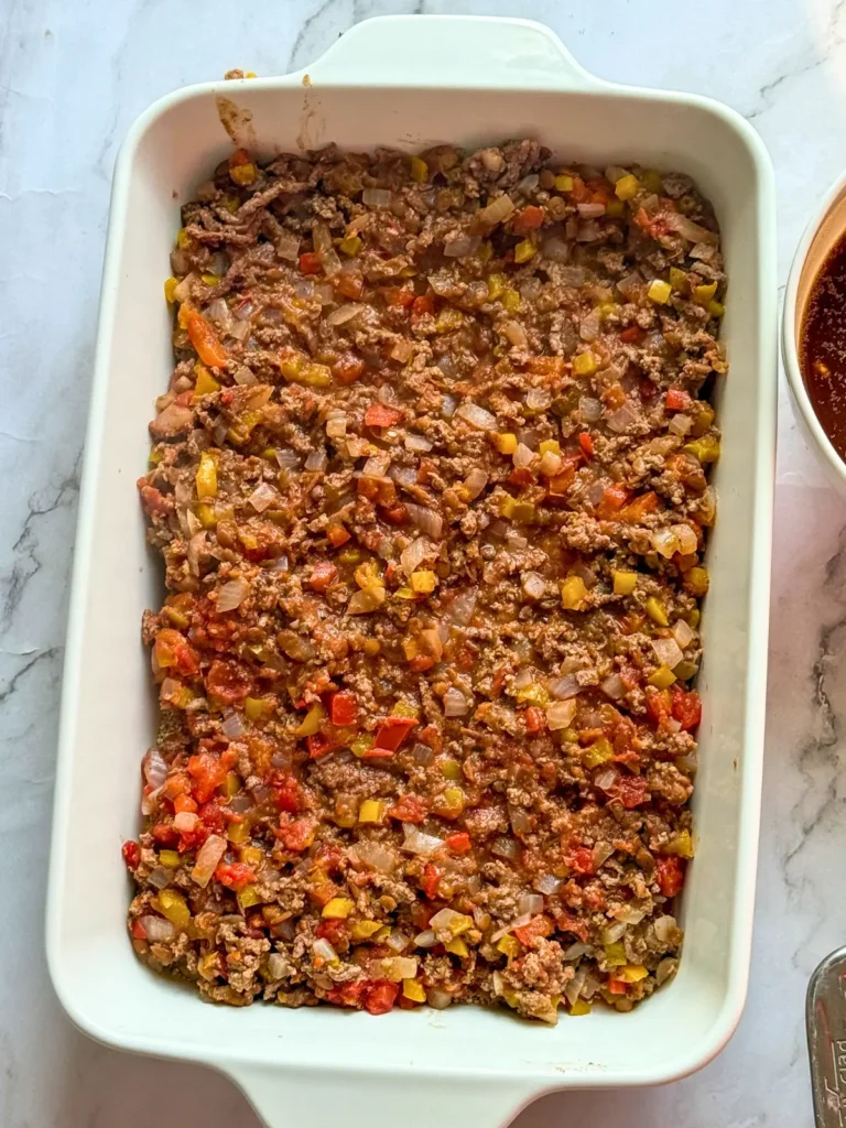 The ground beef mixture added to the casserole dish.