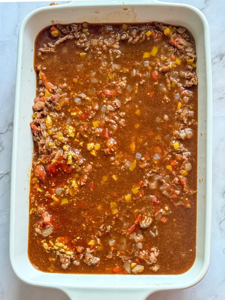 The sauce poured over the casserole dish.