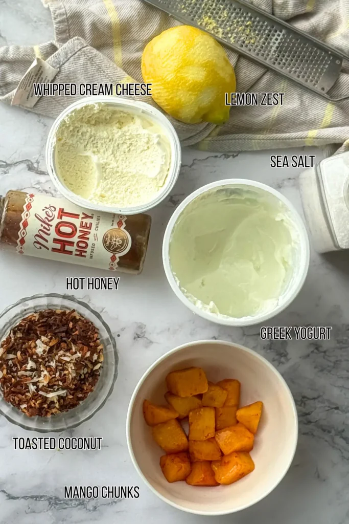 Ingredients for the mango cheesecake yogurt bowls on a counter, 