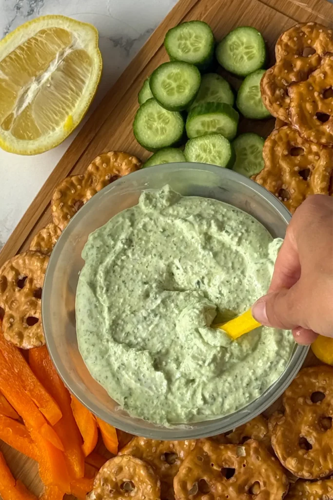 A birds-eye view of a julienne diced bell pepper after dipped into Greek yogurt dip. 
