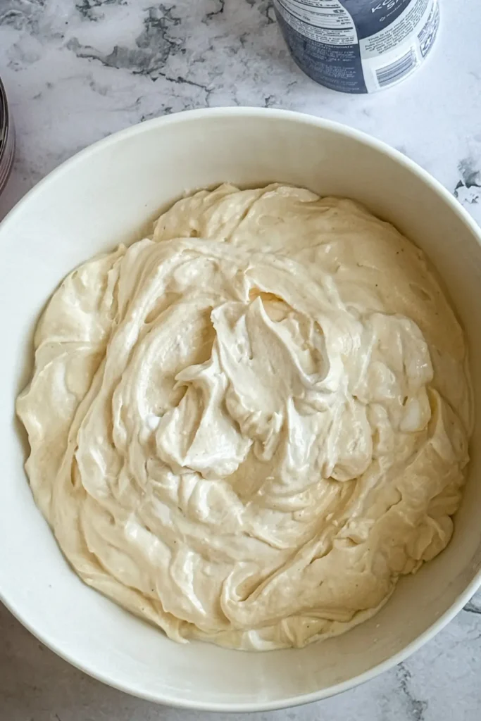 The fluff whisked together in a large white bowl.