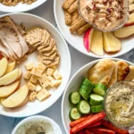 Four fully assembled fall dinner plates on a counter.