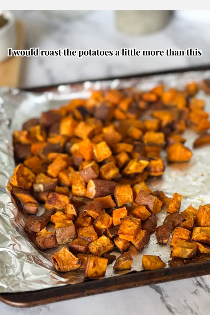 Sweet potatoes on a sheet pan with aluminum foil after roasting.