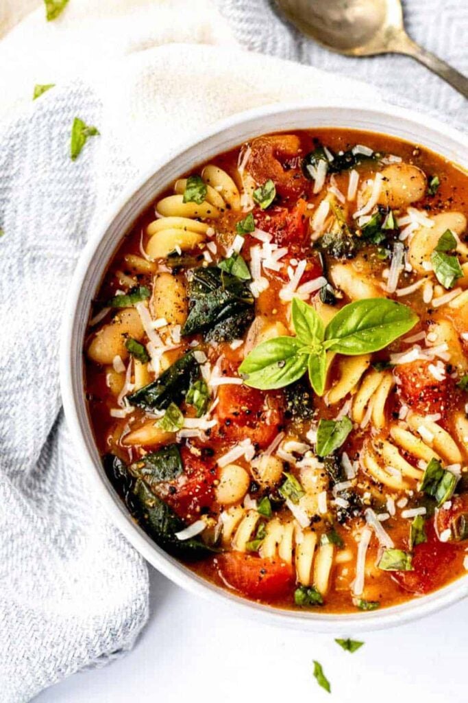 A big bowl of Italian white bean soup on a table.