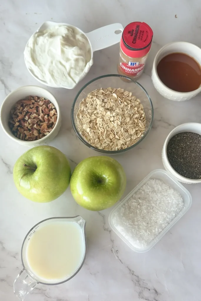 Ingredients portioned out for the salted caramel apple overnight oats on a counter.