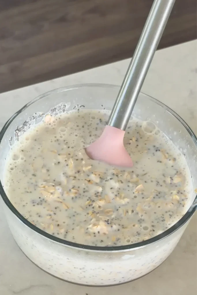 The combined overnight oats mixture in a large glass bowl on a counter.