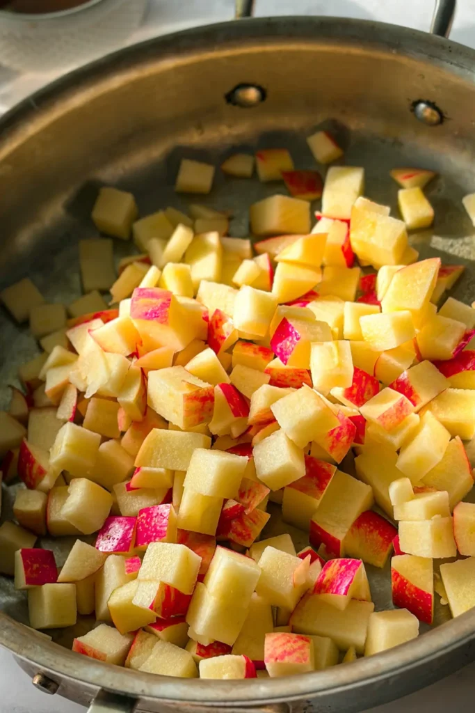 Diced and cubed apples in a pan.