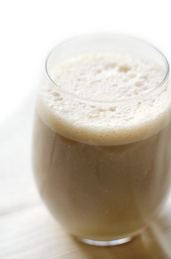 A creamy bean smoothie in a glass on a counter.