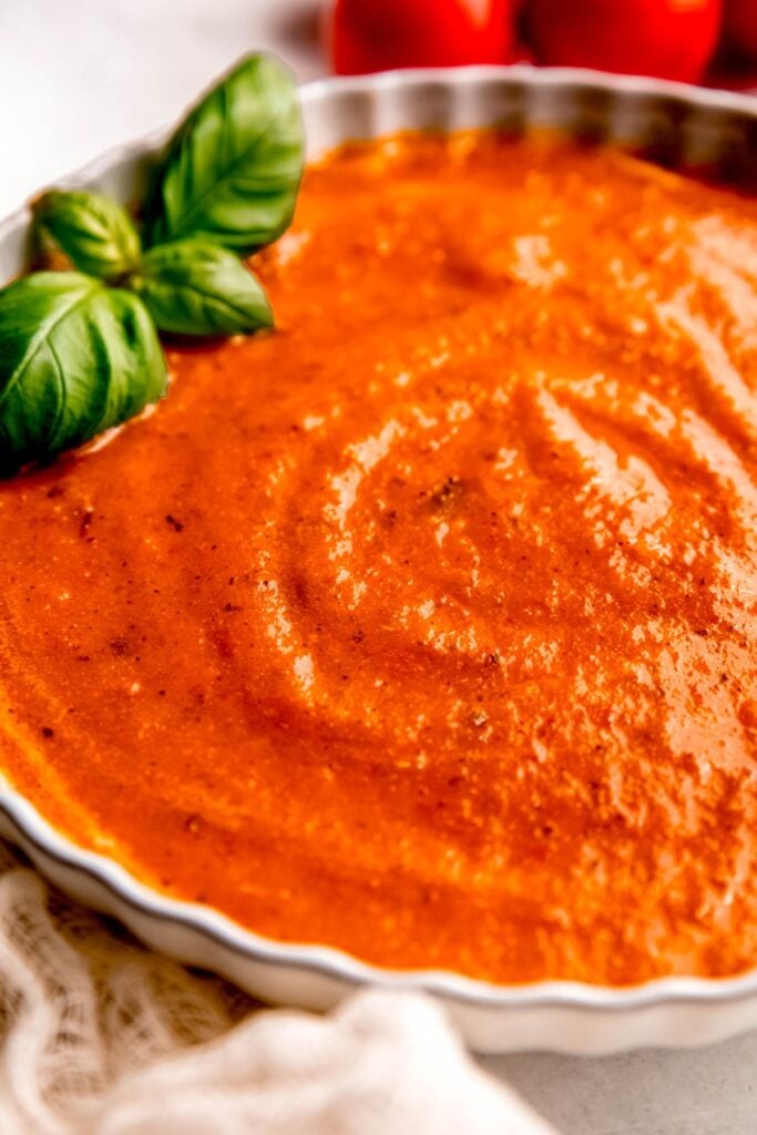 Bowl of roasted tomato soup on a counter.